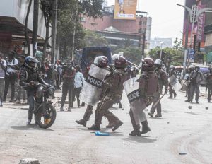 Police officers halt a motor bike rider during the anti finance 2024 finance bill in Kenya. Photo Frank Omondi