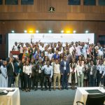 A group phoyo of EAIGF 2024 participants standing on a podium