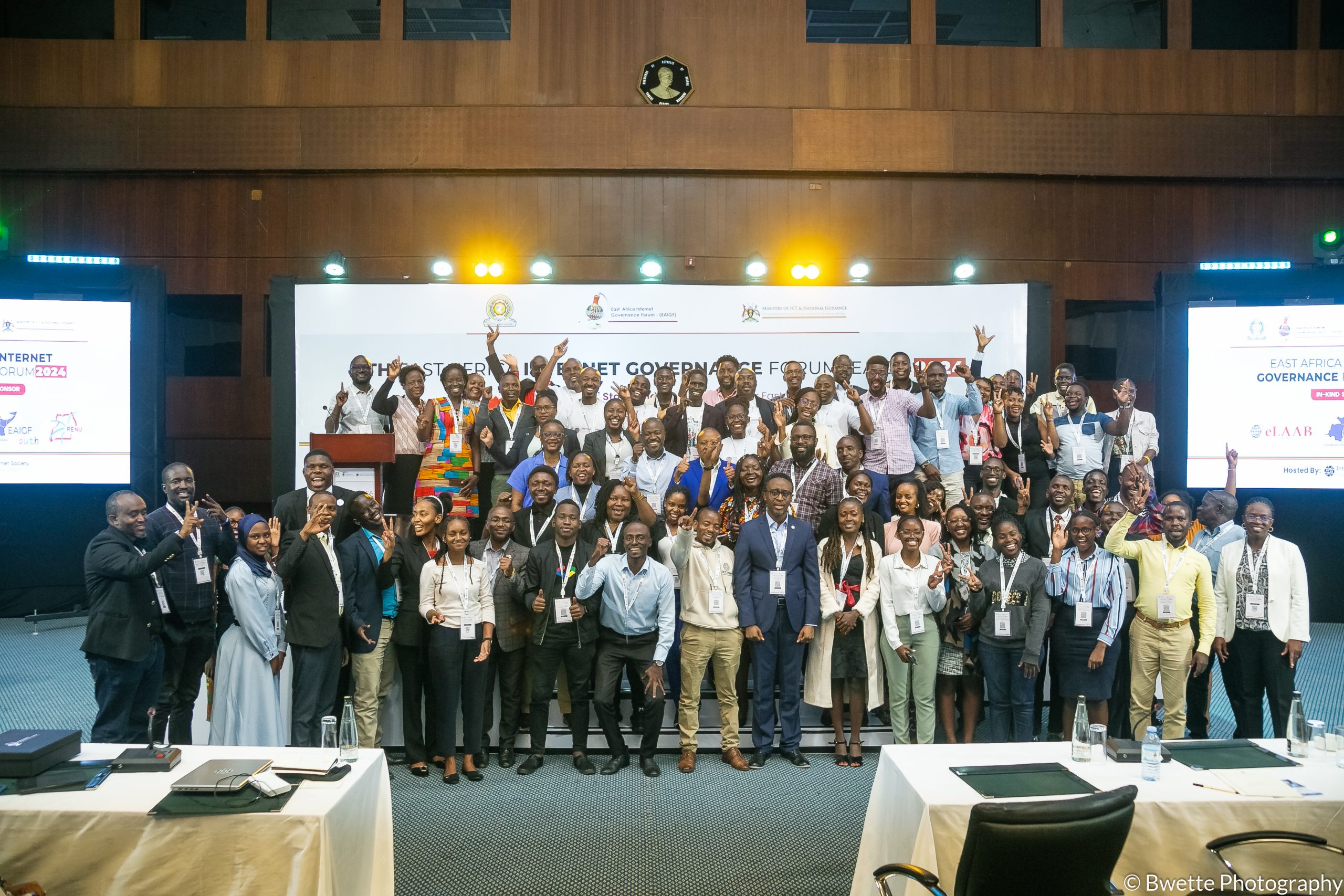 A group phoyo of EAIGF 2024 participants standing on a podium