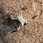 A drone photographed against parched and cracked earth