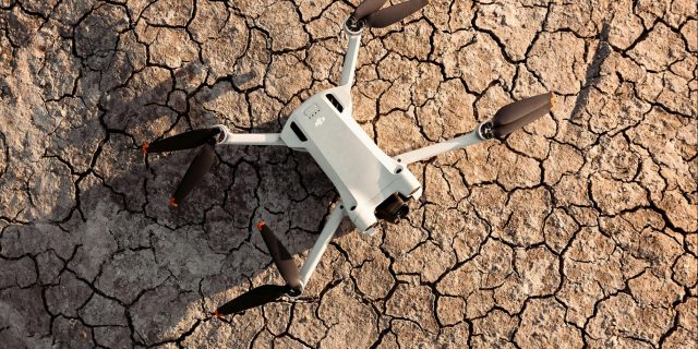 A drone photographed against parched and cracked earth