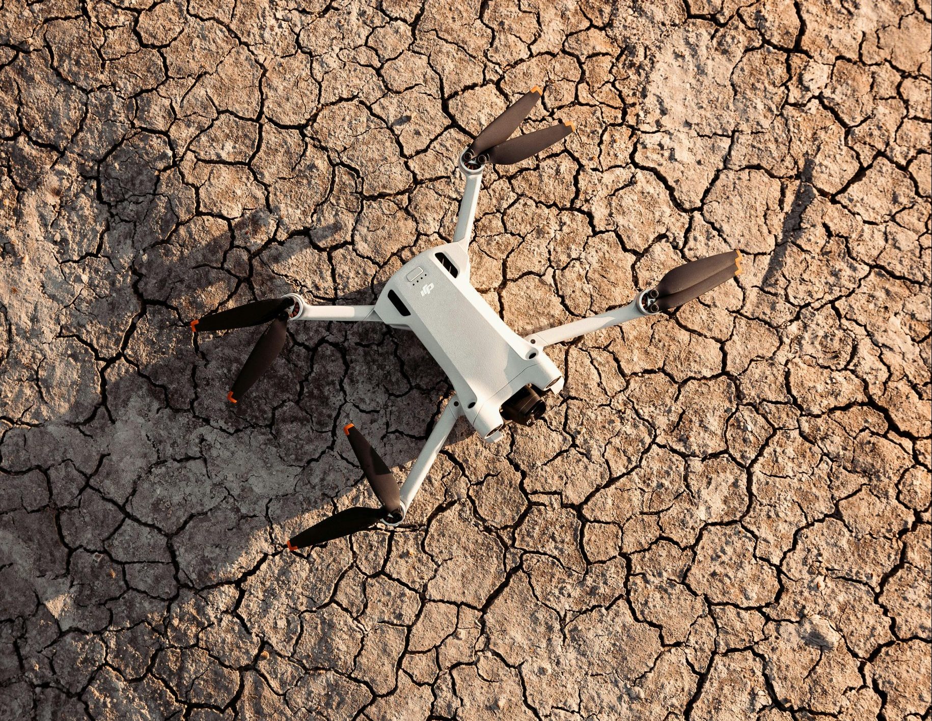 A drone photographed against parched and cracked earth