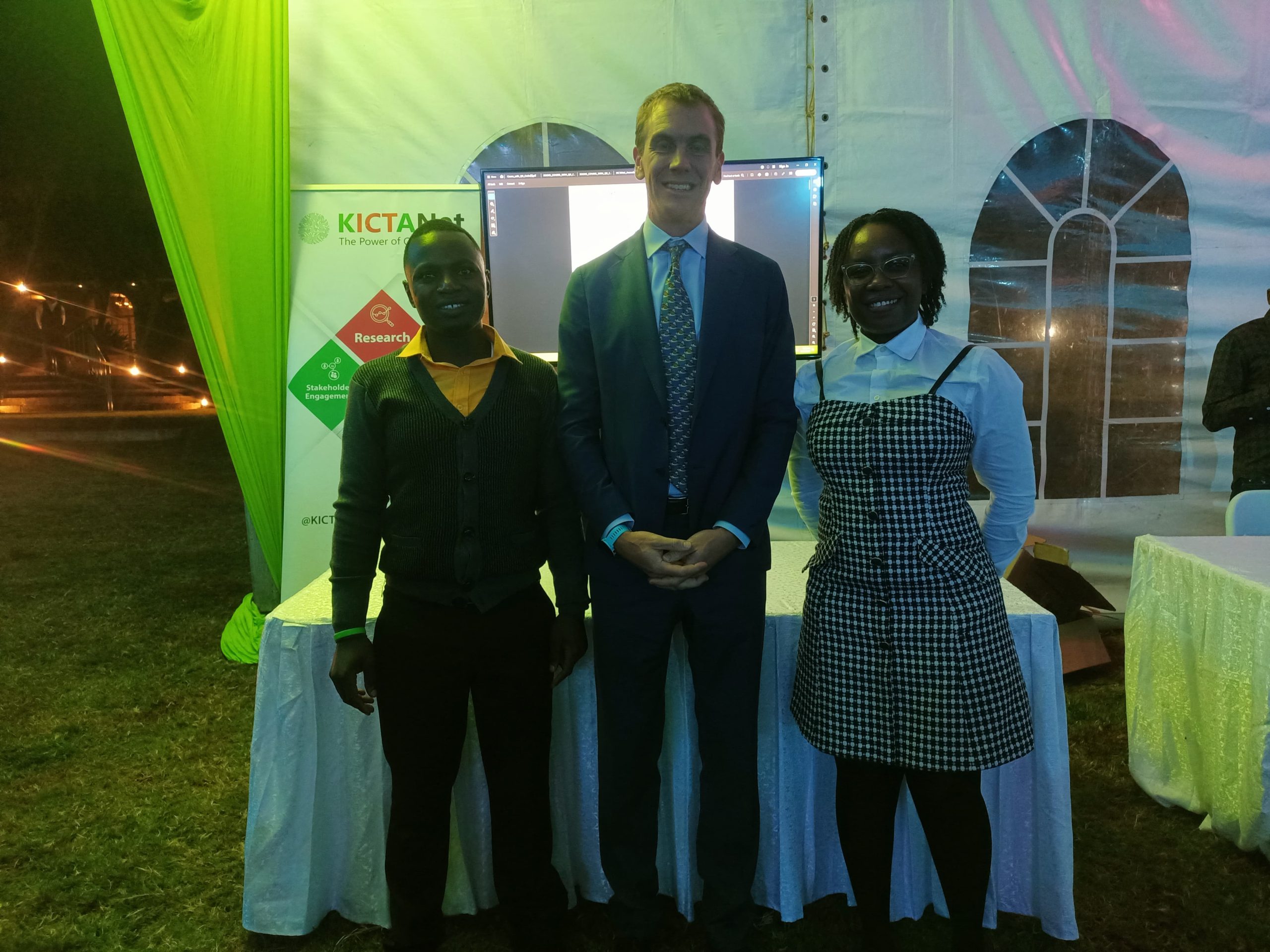 Florence and Nicodemus flank the Deputy British High Commissioner Dr. Ed Barnett