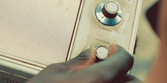 Person Holding Radio Volume Knob PHOTP - Nicholas Githiri