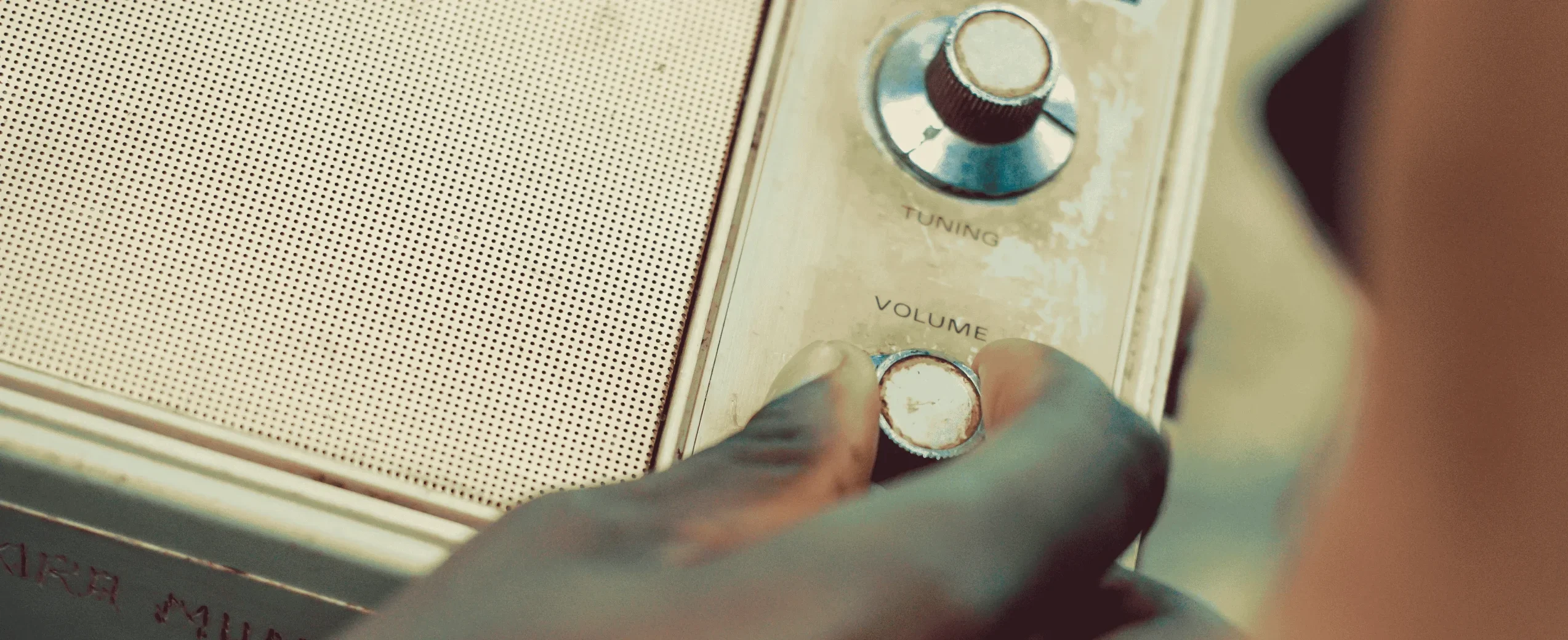 Person Holding Radio Volume Knob PHOTP - Nicholas Githiri